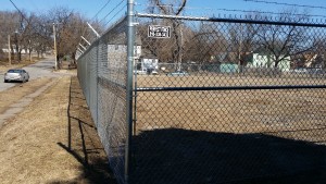 Galvanized Chain link fence with barb wire that was replaced by Perfect Fence.