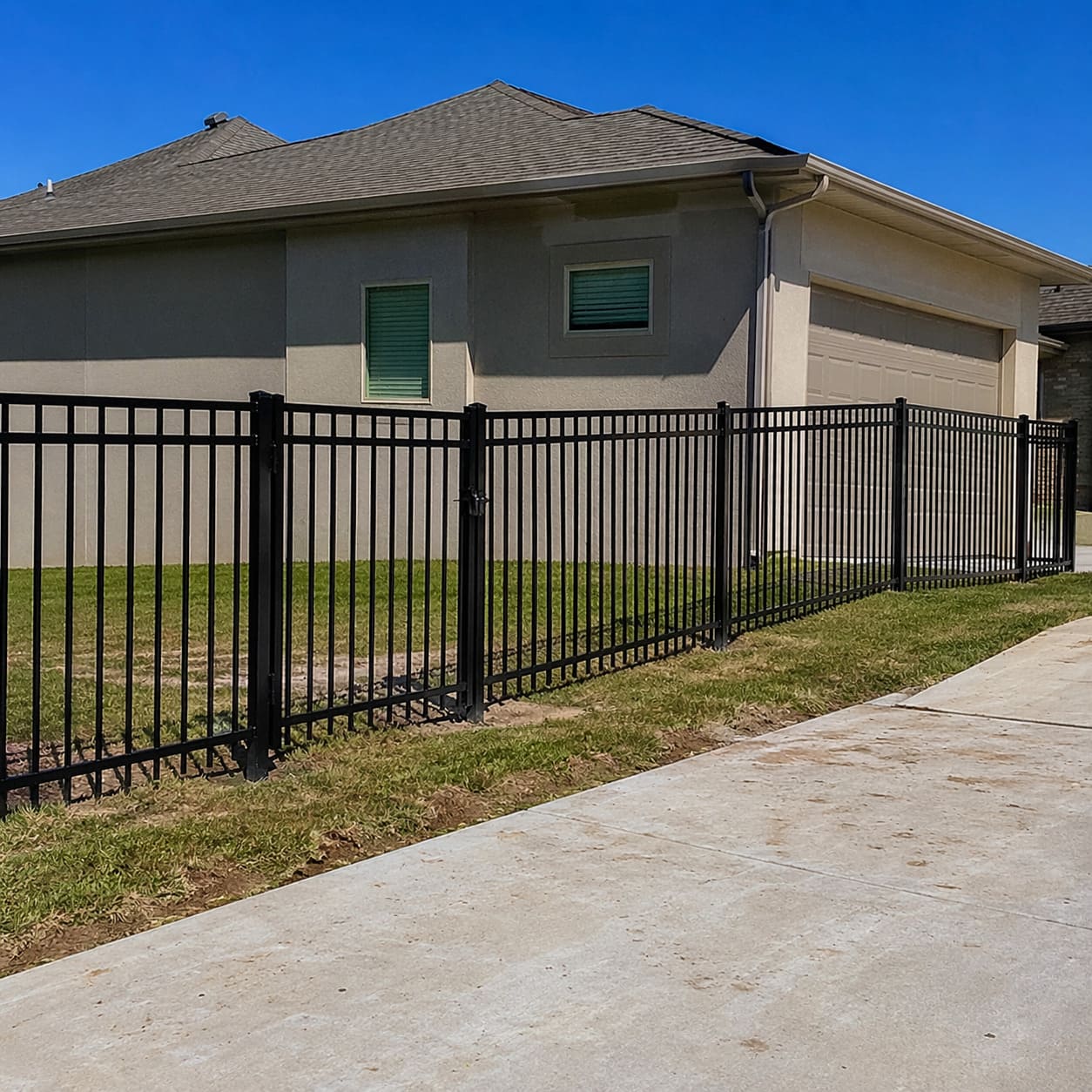 Ornamental Metal Fence – Black metal railing fence along residential driveway boundary - Sample Image